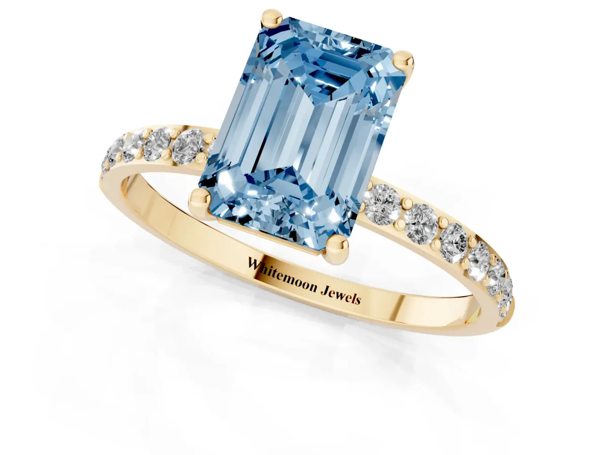 Fancy Blue Emerald Cut Diamond Solitaire Ring with Round Pavé Shoulders and Prong Setting Yellow gold