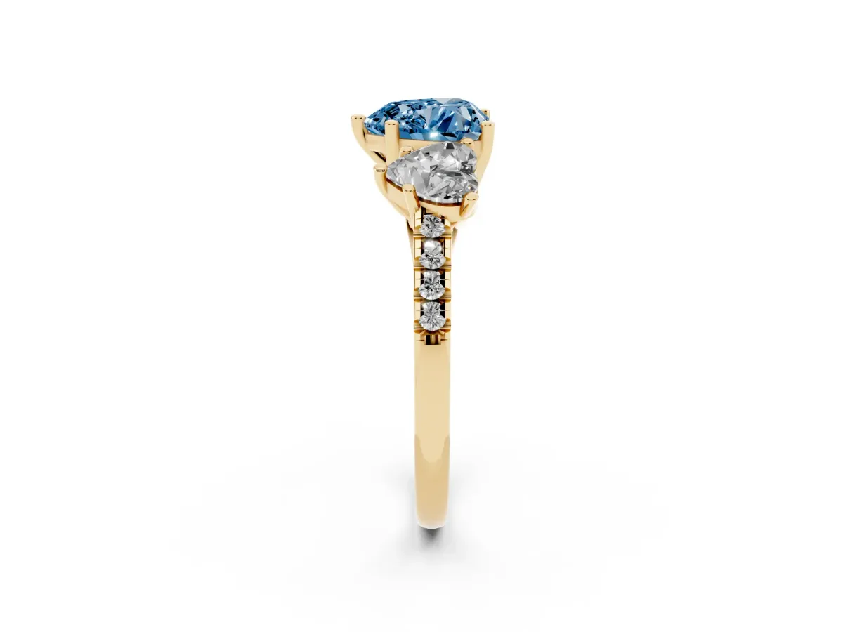 Fancy Blue Three-Stone Heart Cut Diamond Ring with Round Pavé Band and Prong Setting Yellow gold