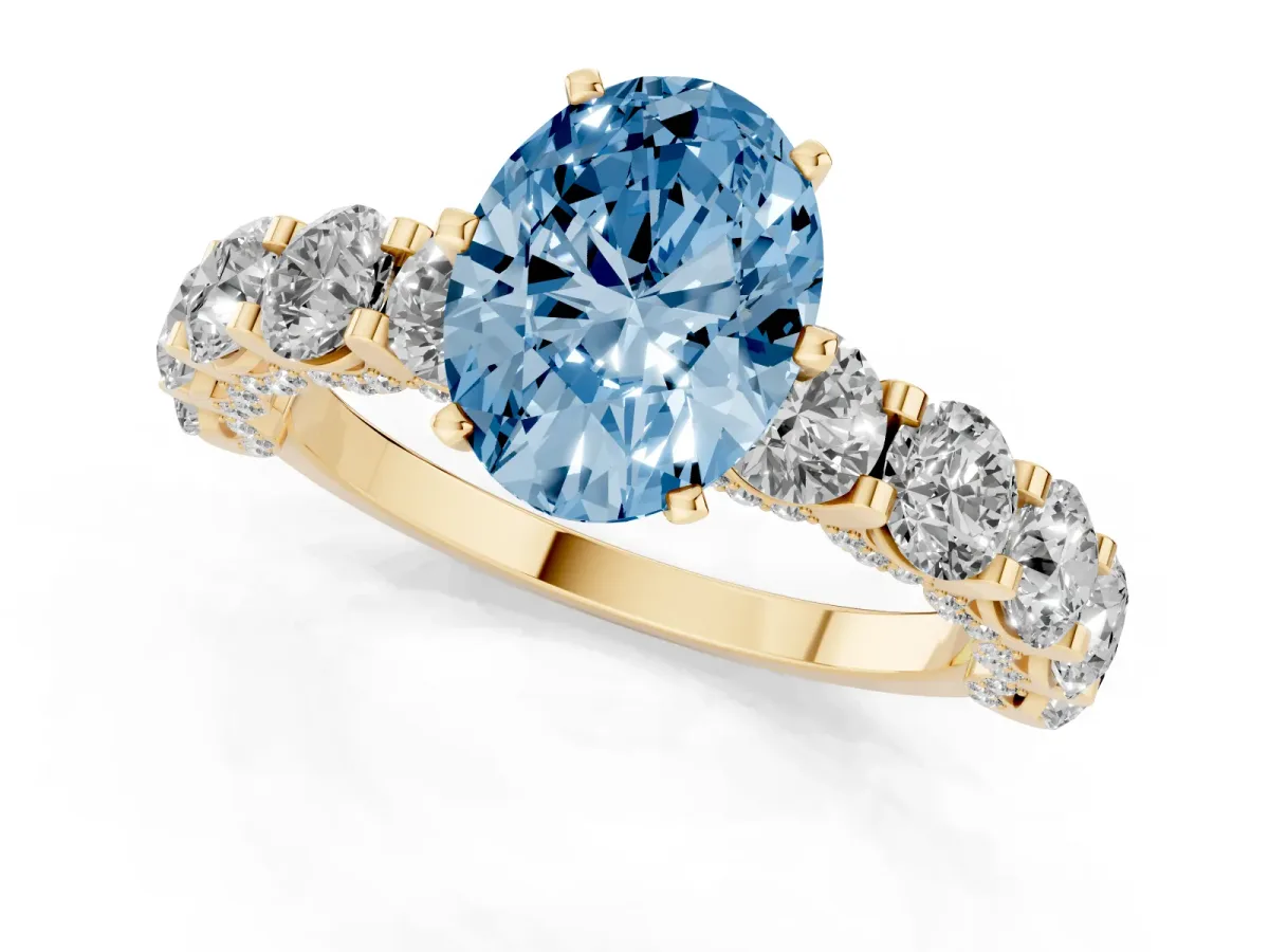 Fancy Blue Oval Cut Diamond Side Stone Engagement Ring with Four-Prong Setting Yellow gold
