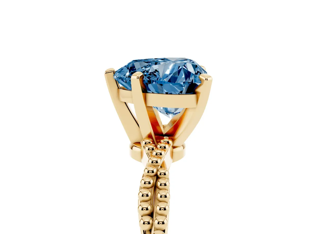 Fancy Blue Heart Cut Solitaire Twisted Band with Bead Prong Setting Yellow gold
