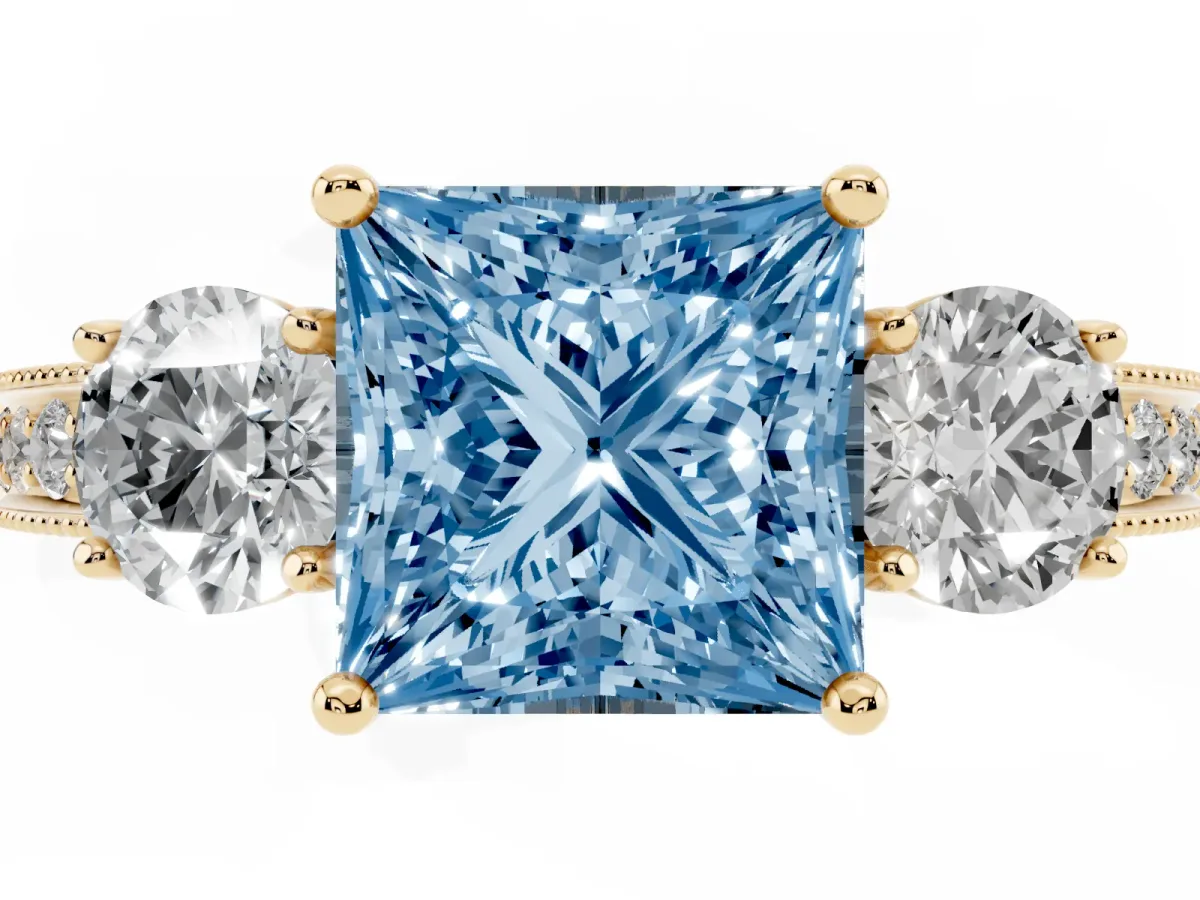 Fancy Blue Princess Cut Three-Stone Diamond Ring with Pavé Band and Four-Prong Setting Yellow gold