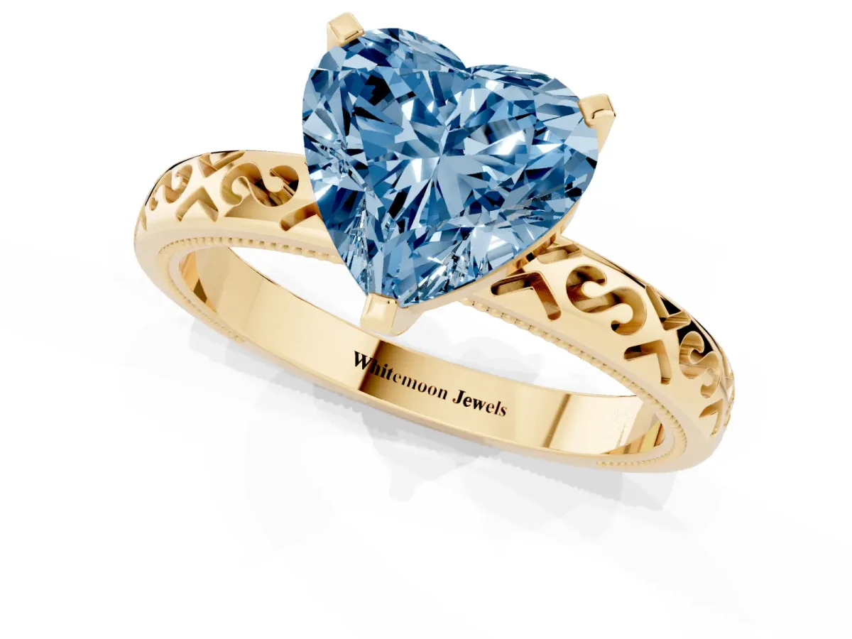 Fancy Blue Heart Cut Solitaire Engagement Ring with Scrollwork Band and Four-Prong Setting Yellow gold