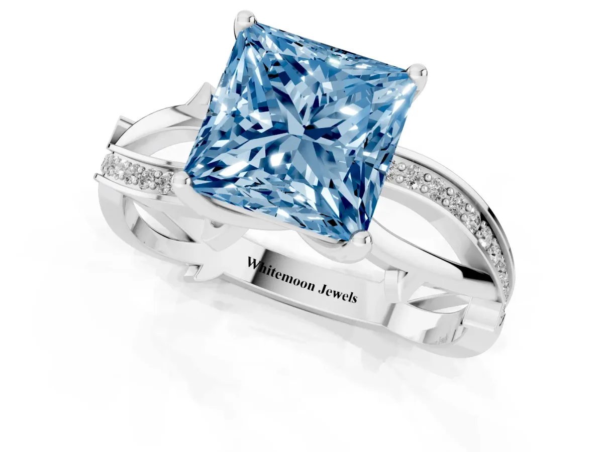 Fancy Blue Princess Cut Solitaire Twist Band with Pavé Accents and Four-Prong Setting Silver