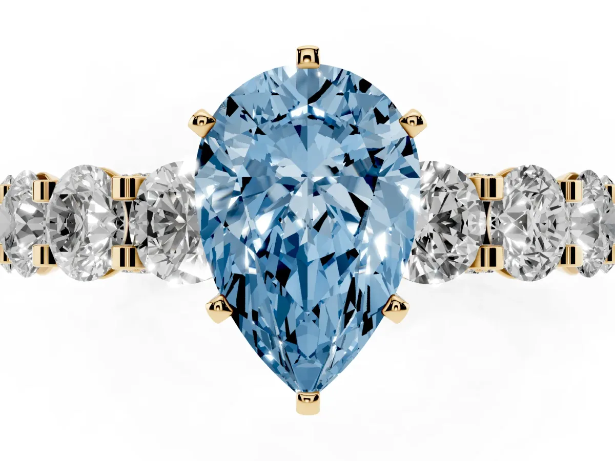 Fancy Blue Pear Cut Diamond Side Stone Engagement Ring with Four-Prong Setting Yellow gold