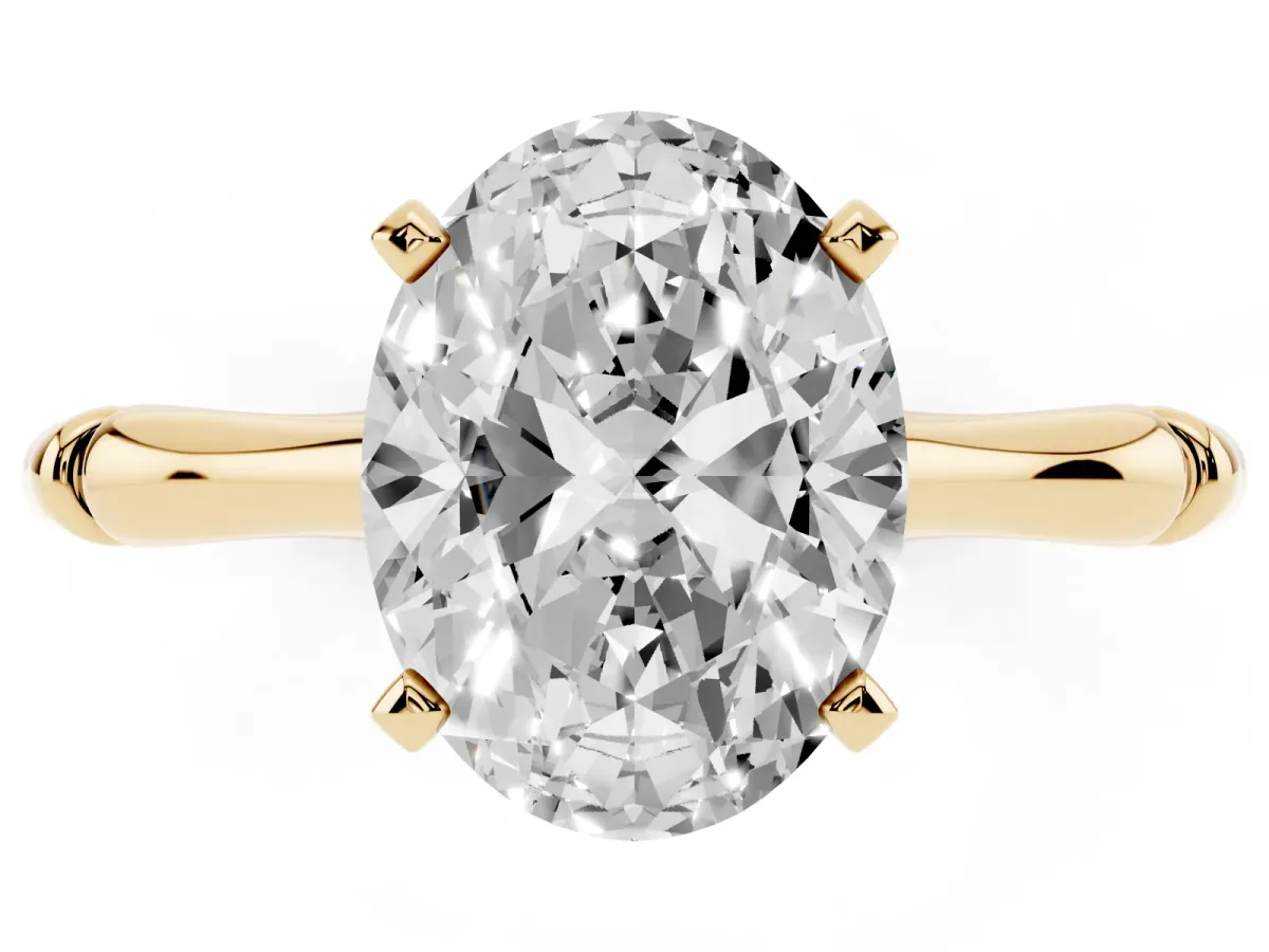 Oval Cut Solitaire Diamond Ring with Bamboo Band and Four-Prong Setting Yellow gold