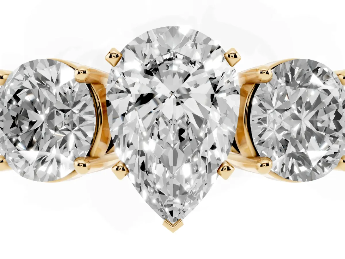 Three-Stone Pear Cut Diamond Ring with Round Side Stones, Classic Band, and Four-Prong Setting Yellow gold