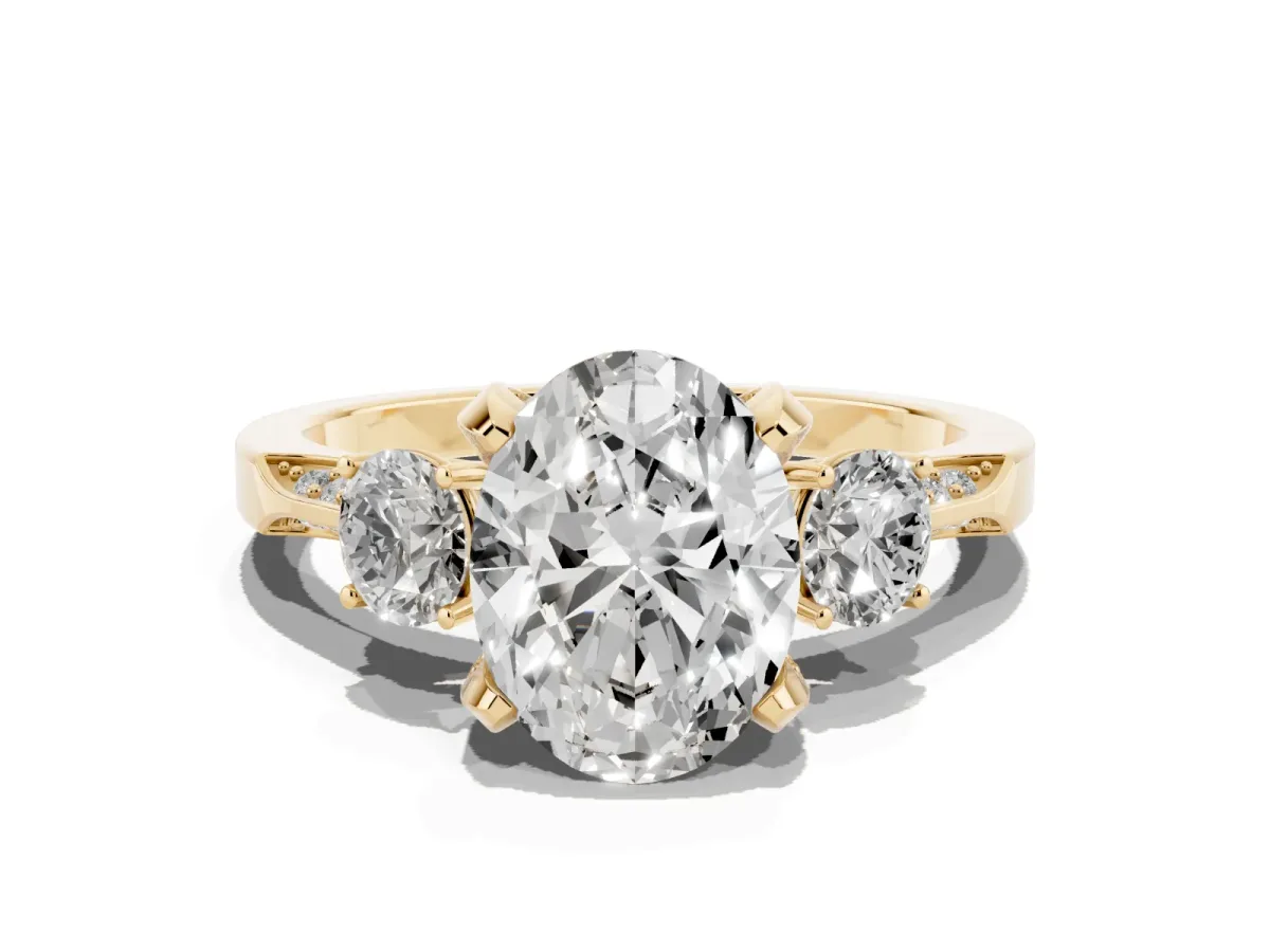 Oval Cut Brilliant Three-Stone Diamond Ring with Pavé Band and Four-Prong Setting Yellow gold