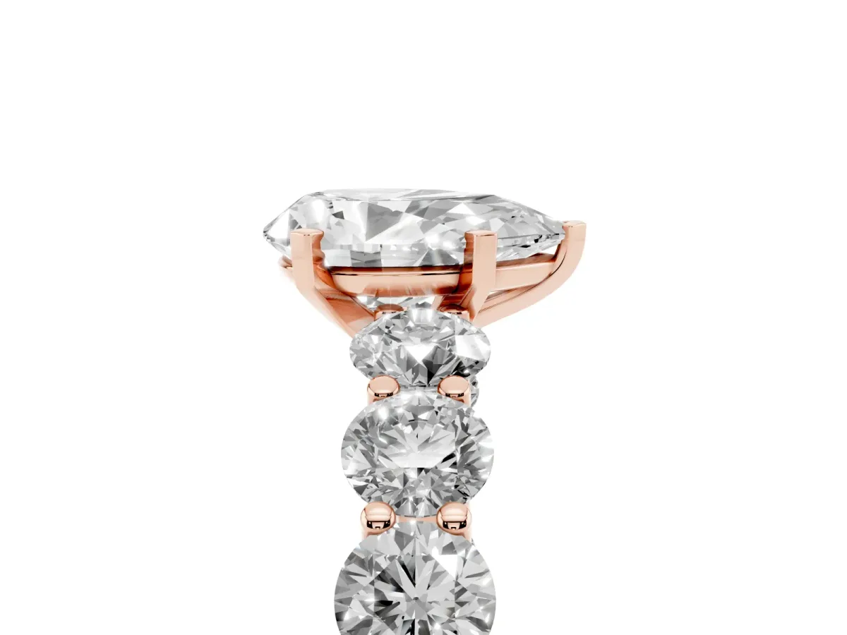 Pear Cut Diamond Prong Setting with Side Stones on a Pave Band Rose gold