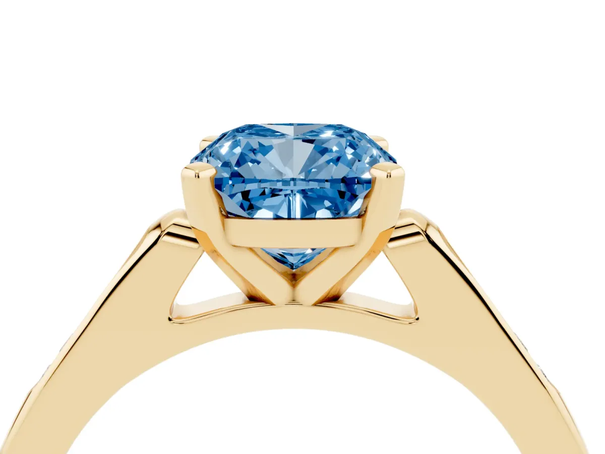 Fancy Blue Cushion Cut Diamond Solitaire Ring with Channel Set Round Band and Prong Setting Yellow gold