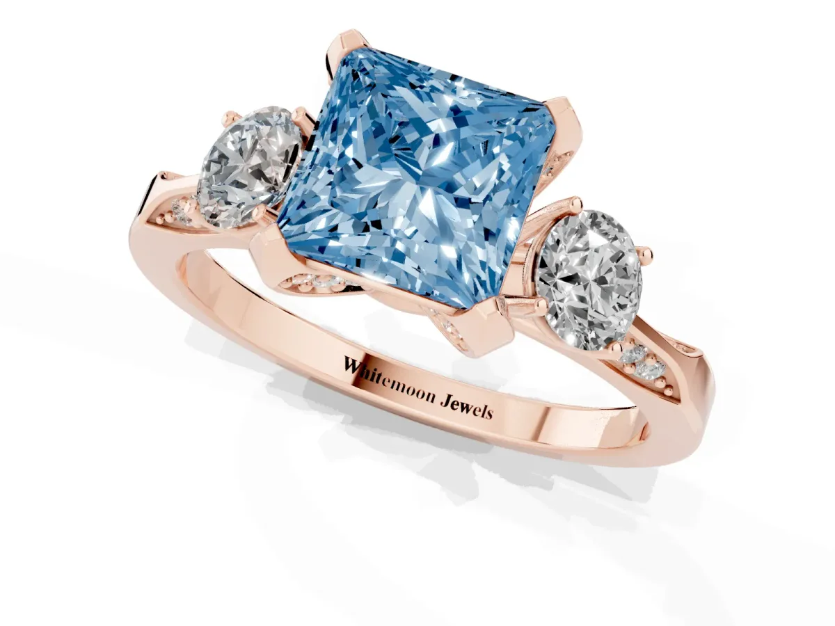 Fancy Blue Princess Cut Brilliant Three-Stone Diamond Ring with Pavé Band and Four-Prong Setting Rose gold