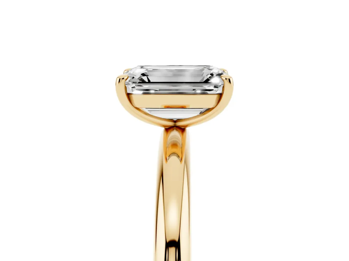 Emerald Cut Solitaire Diamond Ring with Four-Prong Setting on a Plain Band Yellow gold
