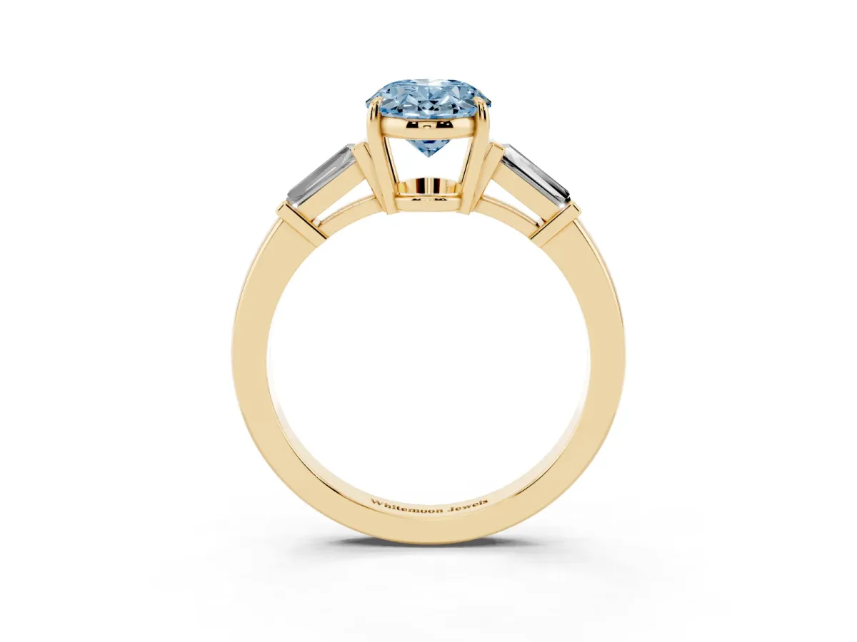 Fancy Blue Oval Cut Diamond Three-Stone Ring with Tapered Baguette Side Stones and Prong Setting Yellow gold