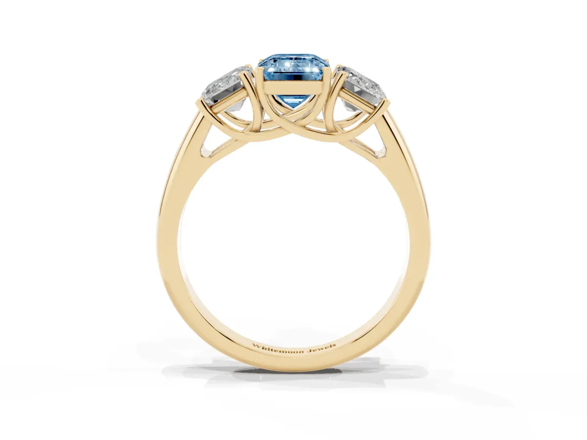 Fancy Blue Three-Stone Emerald Cut Diamond Engagement Ring with Prong Setting Yellow gold