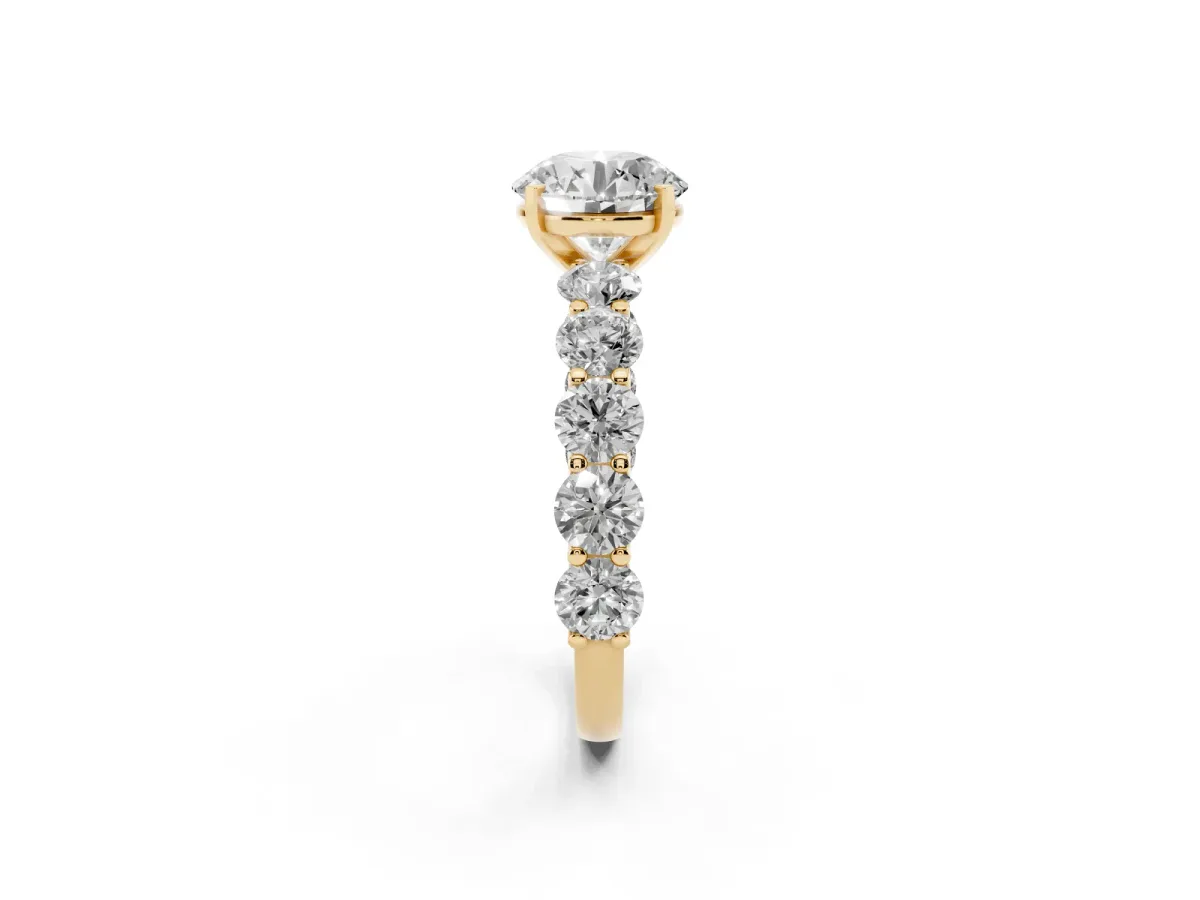 Round Cut Diamond Prong Setting with Side Stones on a Pave Band Yellow gold