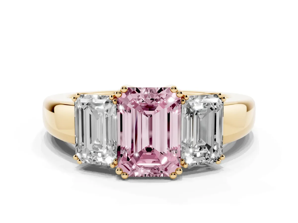 Fancy Pink Three-Stone Emerald Cut Cut Diamond Ring with Channel Set Band and Four-Prong Setting Yellow gold