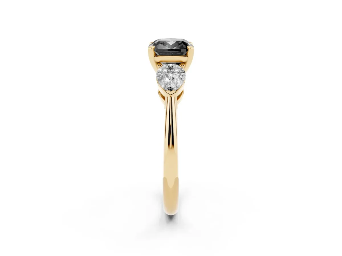 Fancy Black Three-Stone Cushion Cut Diamond Ring with Pear Side Stones and Four-Prong Setting Yellow gold