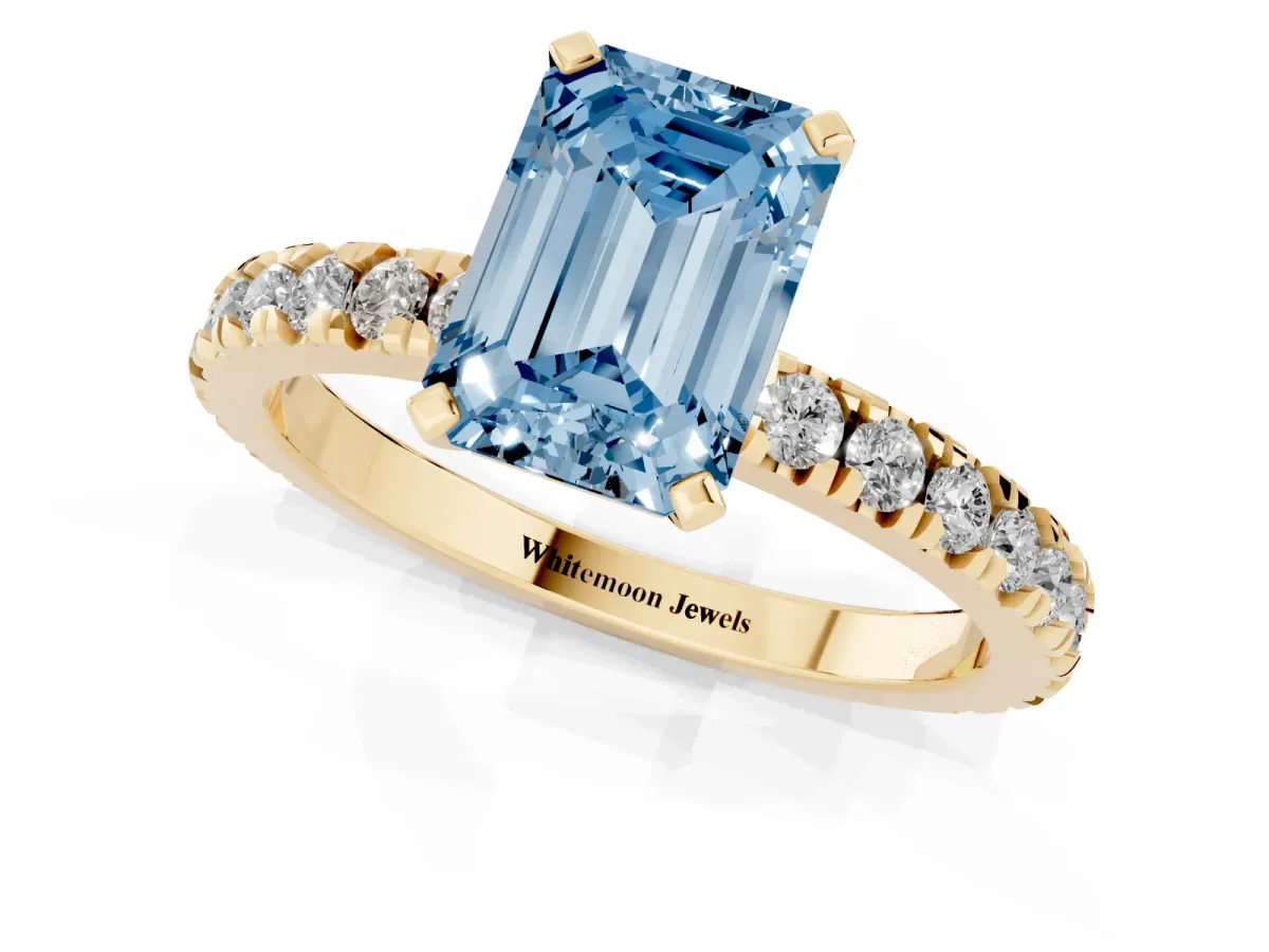 Fancy Blue Emerald Cut Diamond Pavé Band Solitaire with Four-Prong Setting Yellow gold