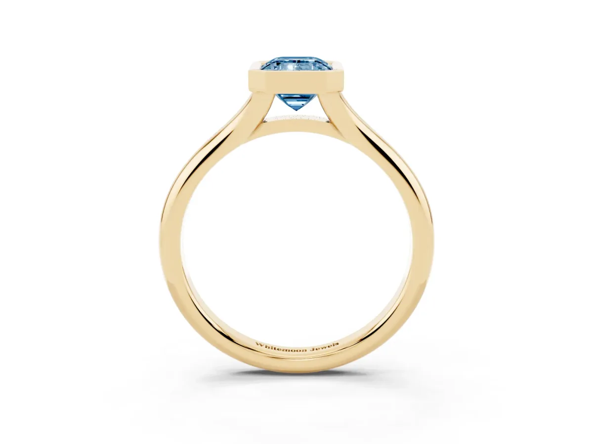 Fancy Blue Bezel Set Emerald Cut Solitaire Diamond Ring with Smooth Band Yellow gold