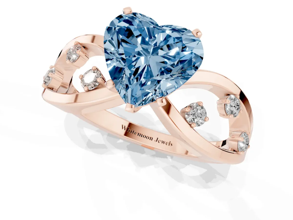 Fancy Blue Heart Cut Cut Solitaire Diamond with Side Stones on Criss-Cross Band and Four-Prong Setting Rose gold