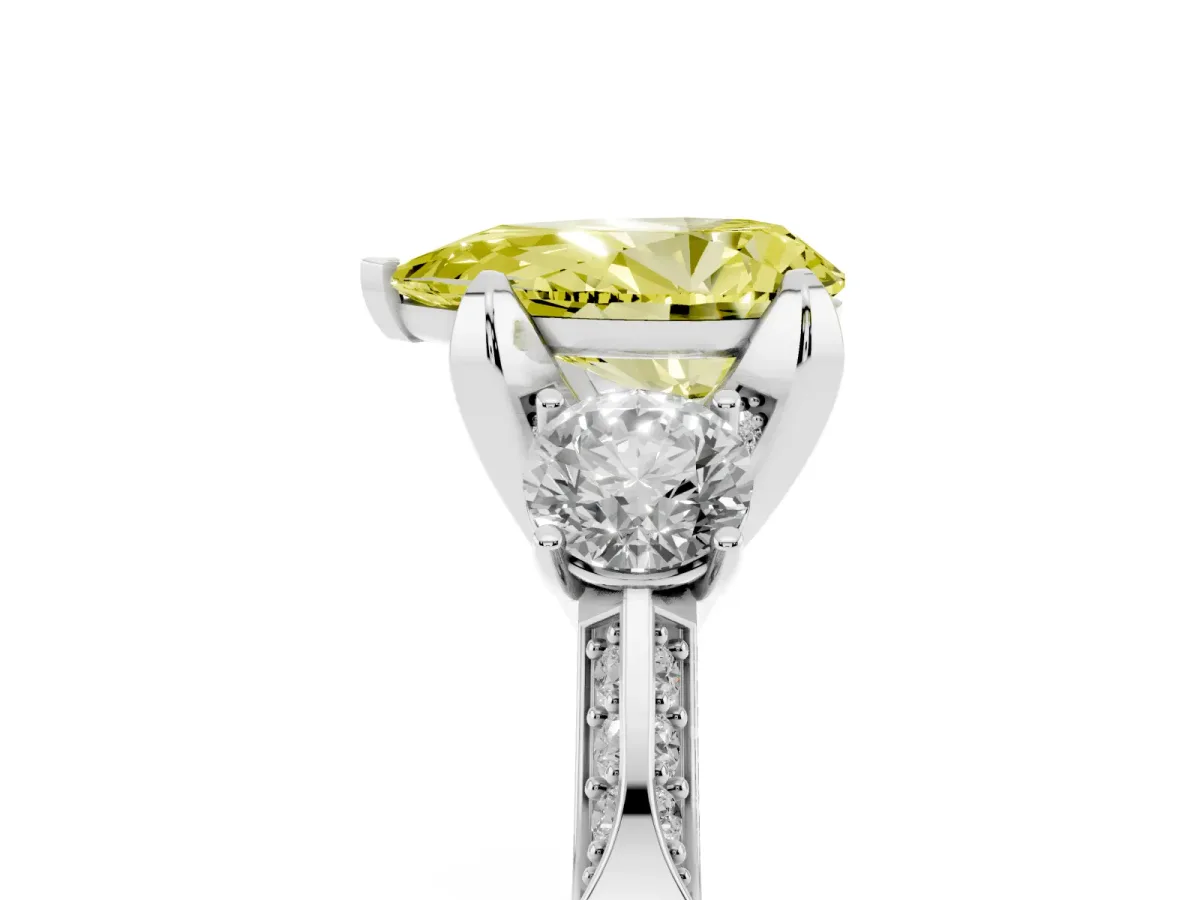 Fancy Yellow Pear Cut Brilliant Three-Stone Diamond Ring with Pavé Band and Four-Prong Setting Platinum