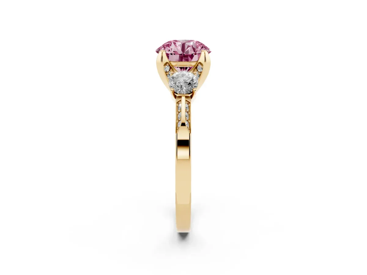 Fancy Pink Round Cut Brilliant Three-Stone Diamond Ring with Pavé Band and Four-Prong Setting Yellow gold