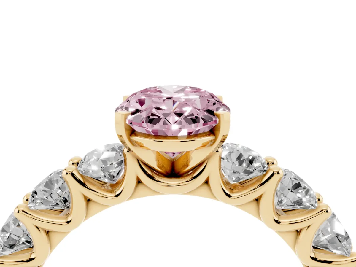 Fancy Pink Oval Cut Diamond Prong Setting with Side Stones on a Pave Band Yellow gold