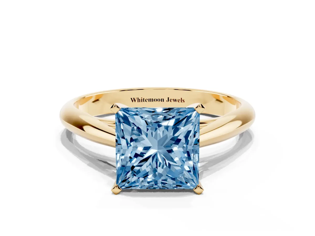 Fancy Blue Princess Cut Diamond Solitaire Engagement Ring with Cathedral Setting and Four-Prong Mount Yellow gold