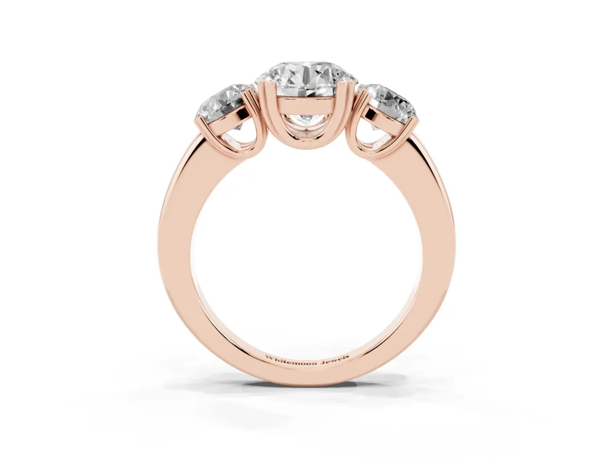 Three-Stone Round Cut Cut Diamond Ring with Channel Set Band and Four-Prong Setting Rose gold