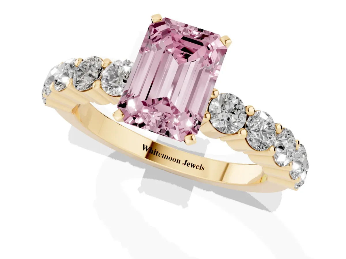 Fancy Pink Emerald Cut Diamond Solitaire Ring with Shared Prong Round Side Stones Yellow gold