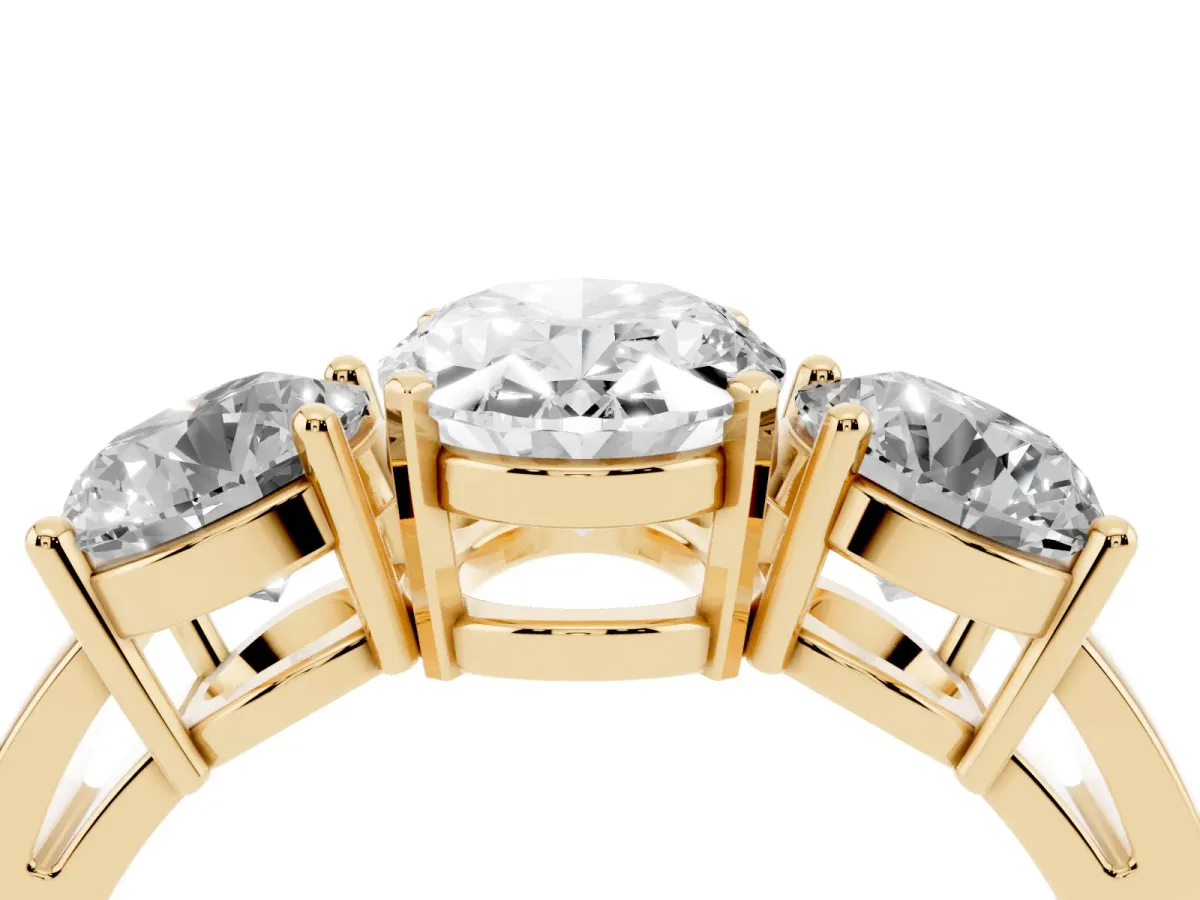 Three-Stone Oval Cut Diamond Ring with Round Side Stones, Classic Band, and Four-Prong Setting Yellow gold