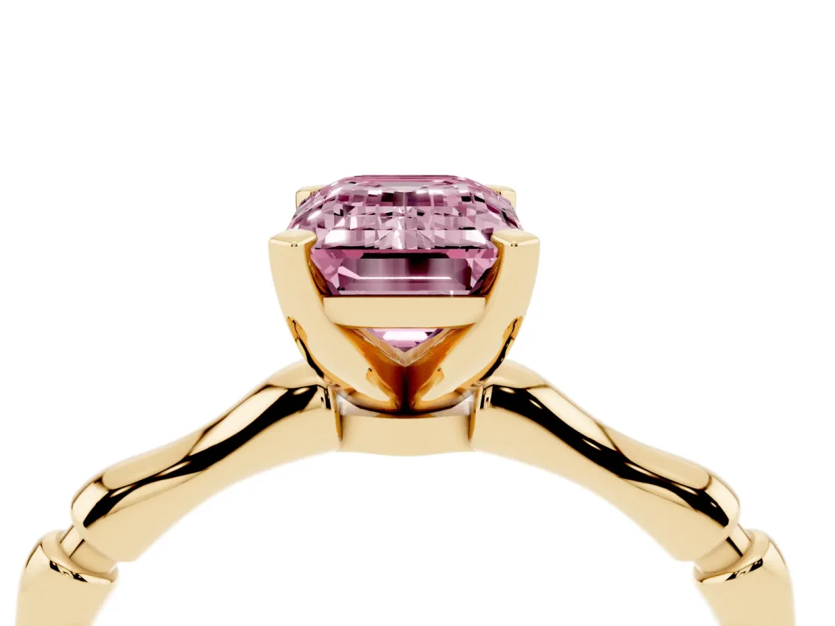Fancy Pink Emerald Cut Solitaire Diamond Ring with Bamboo Band and Four-Prong Setting Yellow gold
