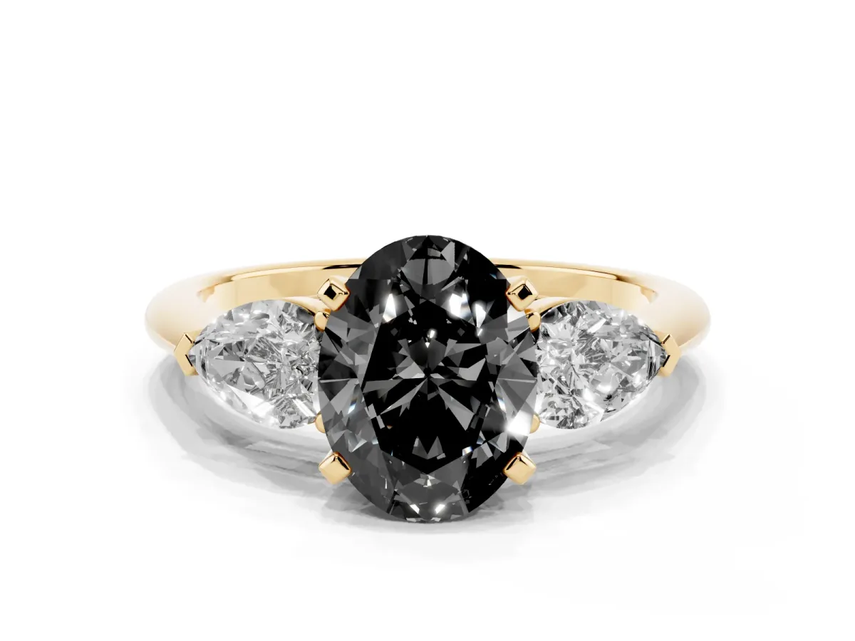 Fancy Black Three-Stone Oval Cut Diamond Ring with Pear Side Stones and Four-Prong Setting Yellow gold
