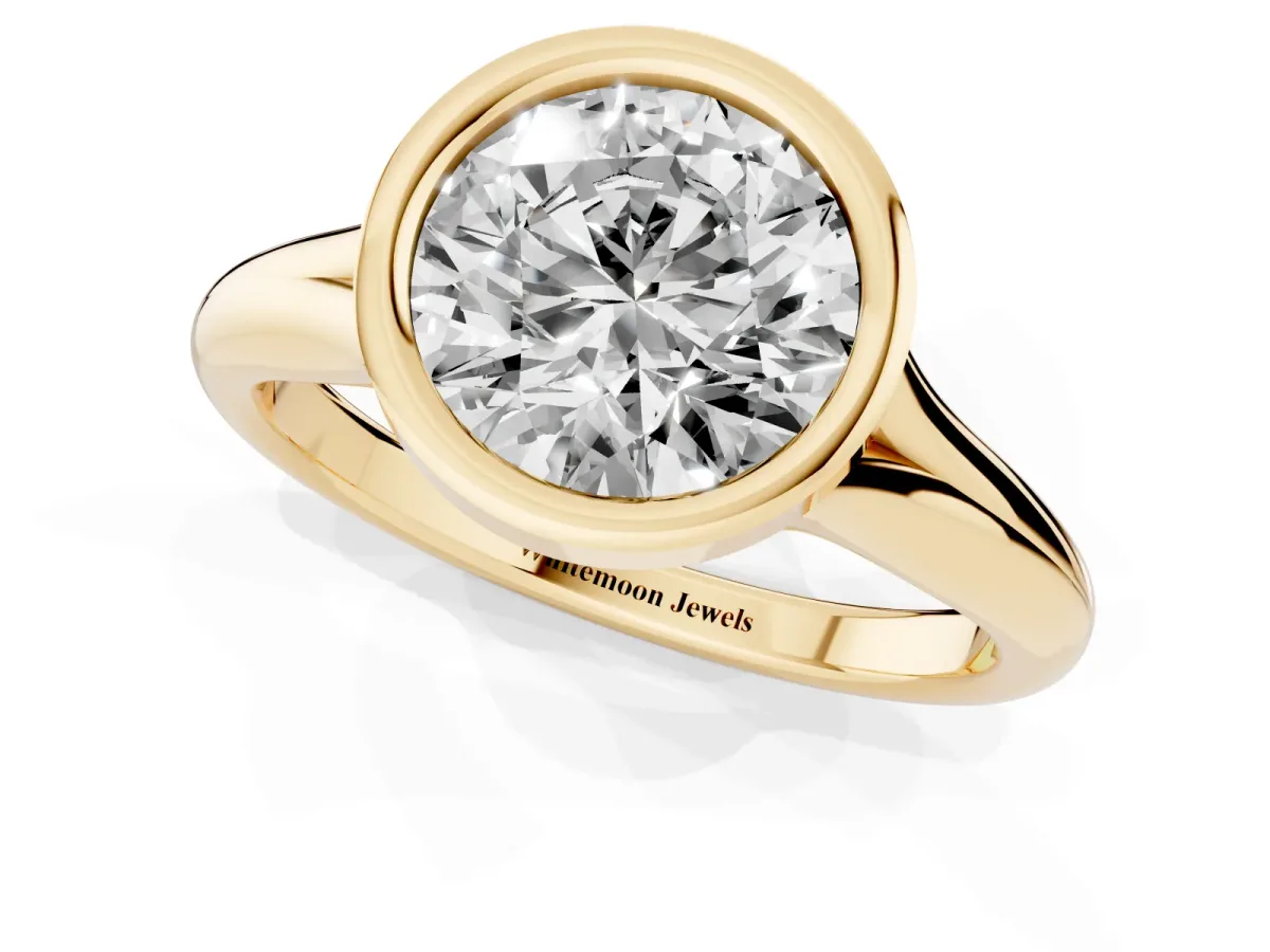 Bezel Set Round Cut Solitaire Diamond Ring with Smooth Band Yellow gold