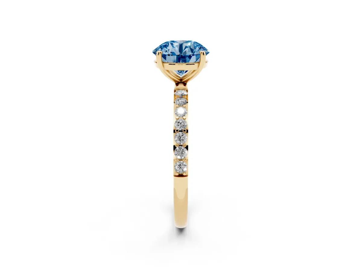 Fancy Blue Round Cut Diamond Solitaire Ring with Round Pavé Shoulders and Prong Setting Yellow gold