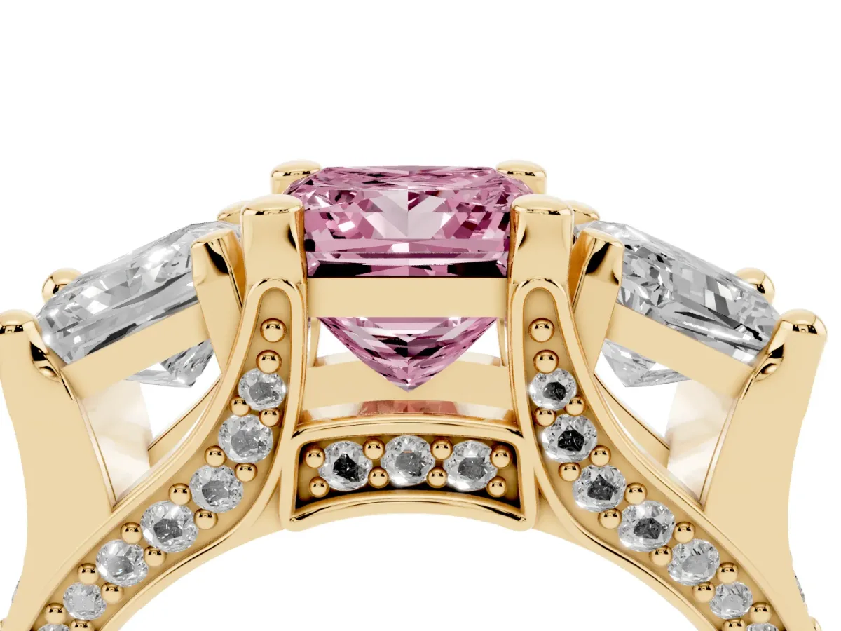 Fancy Pink Princess Cut Diamond Three-Stone Ring with Channel Set Band and Four-Prong Setting Yellow gold