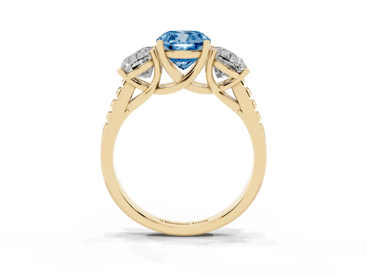 Fancy Blue Three-Stone Cushion Cut Diamond Ring with Round Pavé Band and Prong Setting Yellow gold