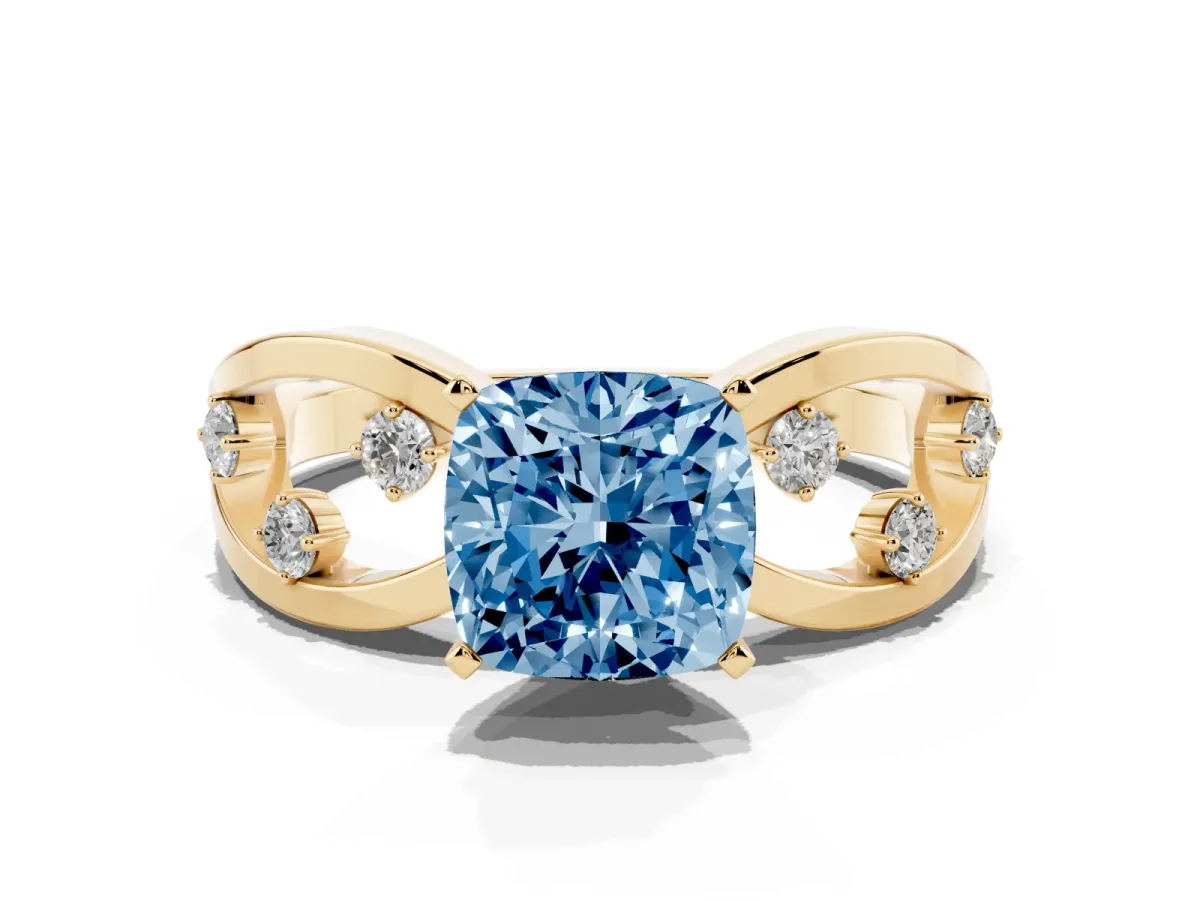 Fancy Blue Cushion Cut Cut Solitaire Diamond with Side Stones on Criss-Cross Band and Four-Prong Setting Yellow gold