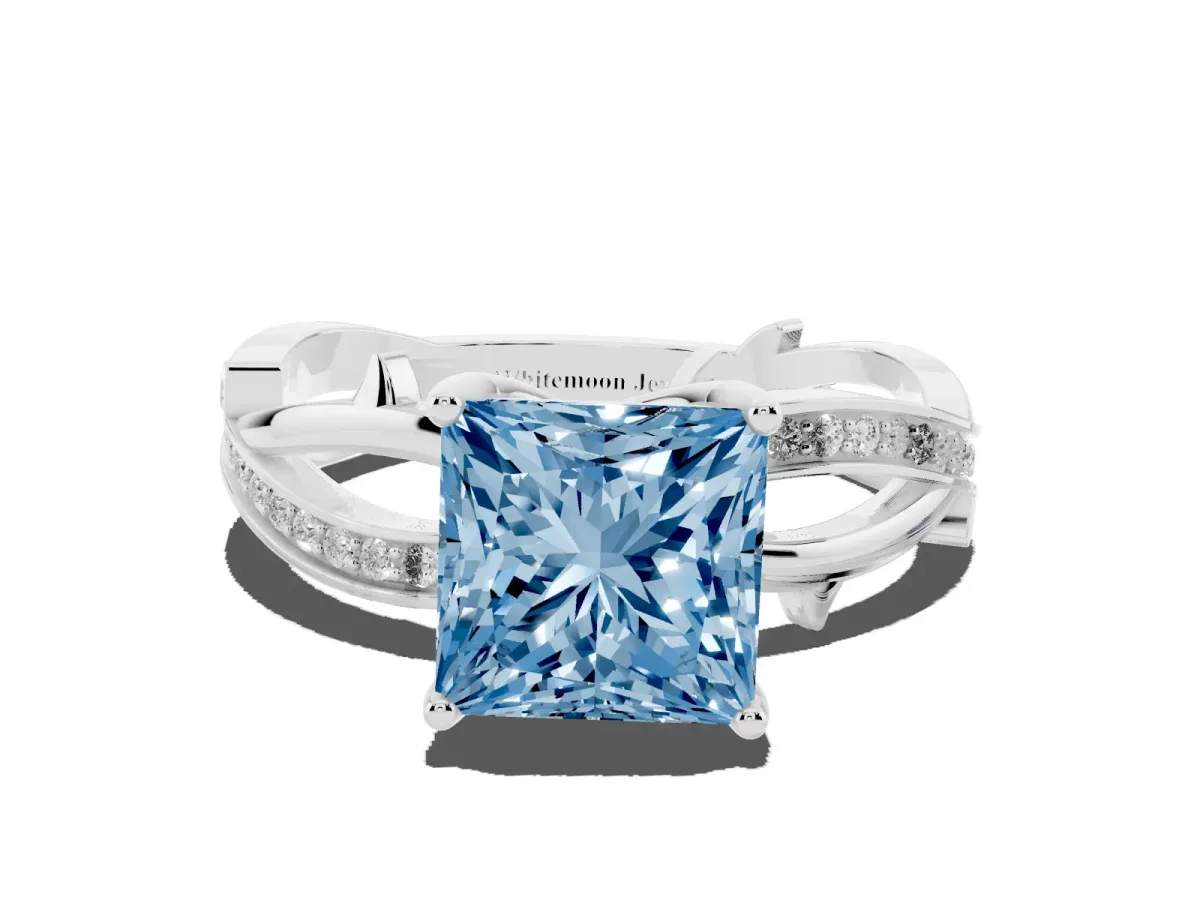 Fancy Blue Princess Cut Solitaire Twist Band with Pavé Accents and Four-Prong Setting Silver