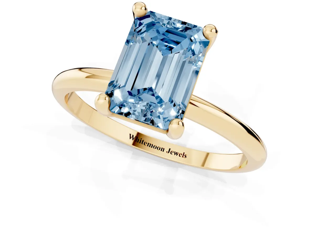 Fancy Blue Emerald Cut Solitaire Diamond Ring with 4-Prong Setting on a Classic Band Yellow gold
