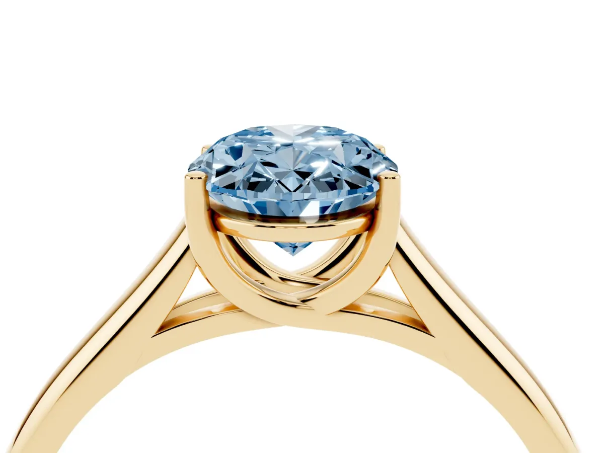 Fancy Blue Oval Cut Solitaire Engagement Ring with Tapered Band and Four-Prong Setting Yellow gold
