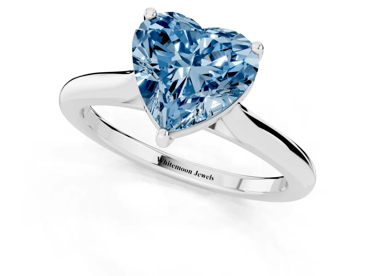 Fancy Blue Heart Cut Cut Solitaire Ring with Cathedral Band and Four-Prong Setting Silver