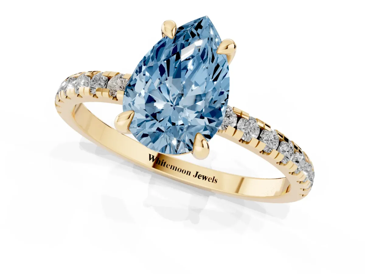 Fancy Blue Pear Cut Diamond Brilliant Solitaire Ring with Pavé Band and Four-Prong Setting Yellow gold