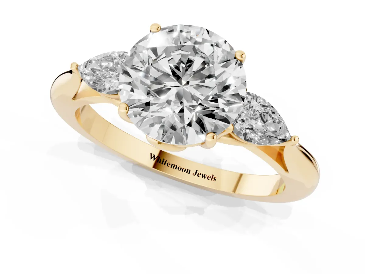 Round Cut Diamond Three-Stone Ring with Pear Side Stones and Prong Setting Yellow gold