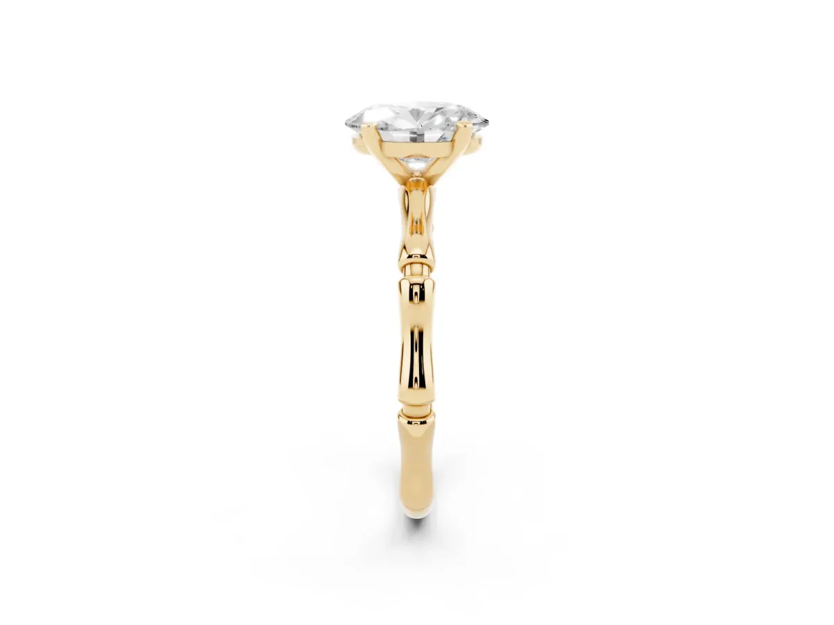 Oval Cut Solitaire Diamond Ring with Bamboo Band and Four-Prong Setting Yellow gold