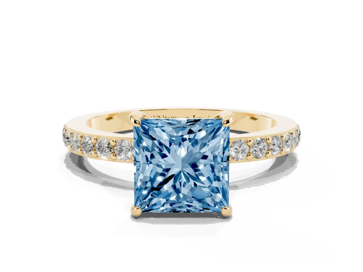 Fancy Blue Princess Cut Diamond Pavé Engagement Ring with Round Accents and Prong Setting Yellow gold