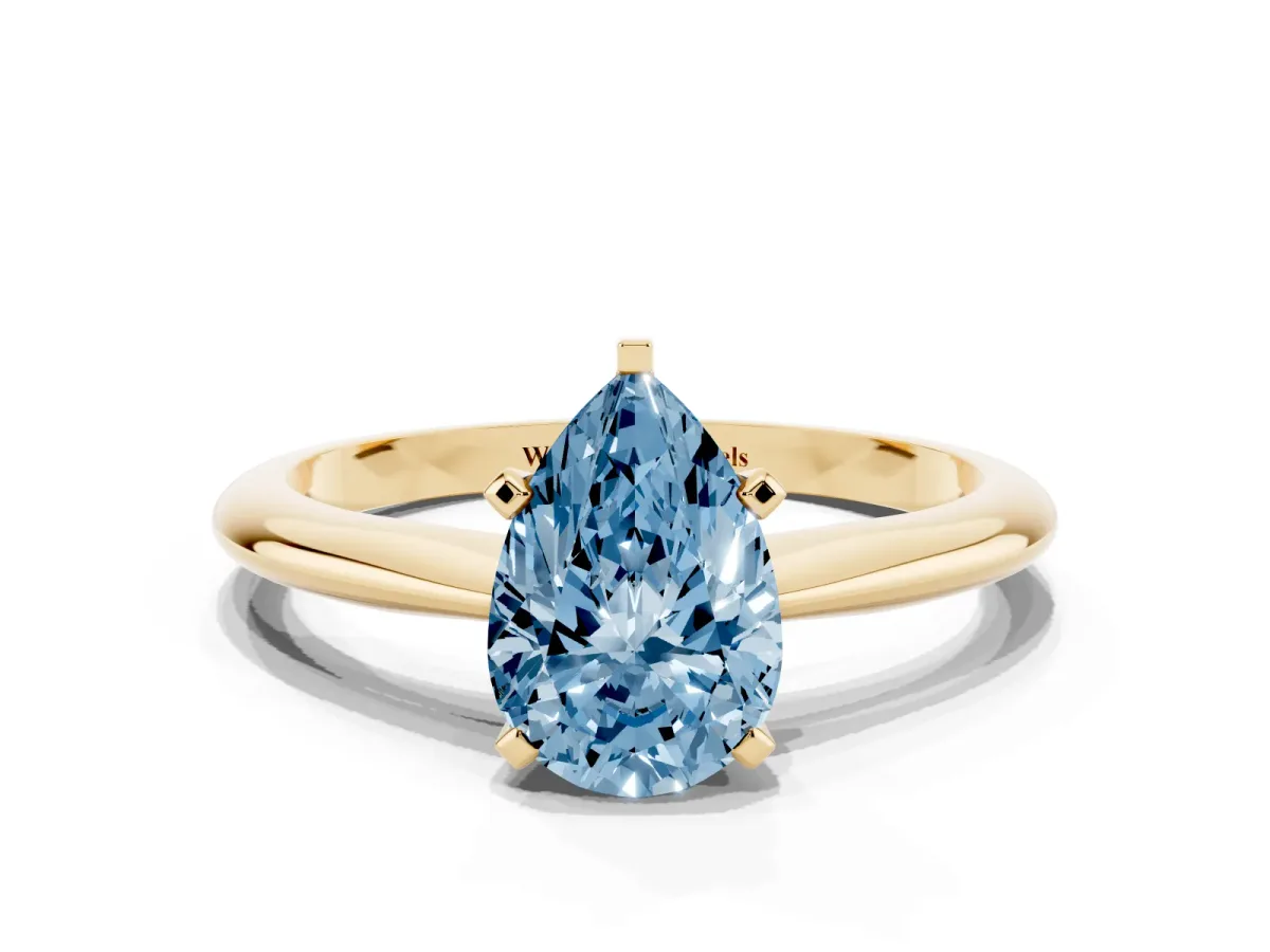 Fancy Blue Pear Cut Cut Solitaire Ring with Four-Prong Setting on a Classic Band Yellow gold