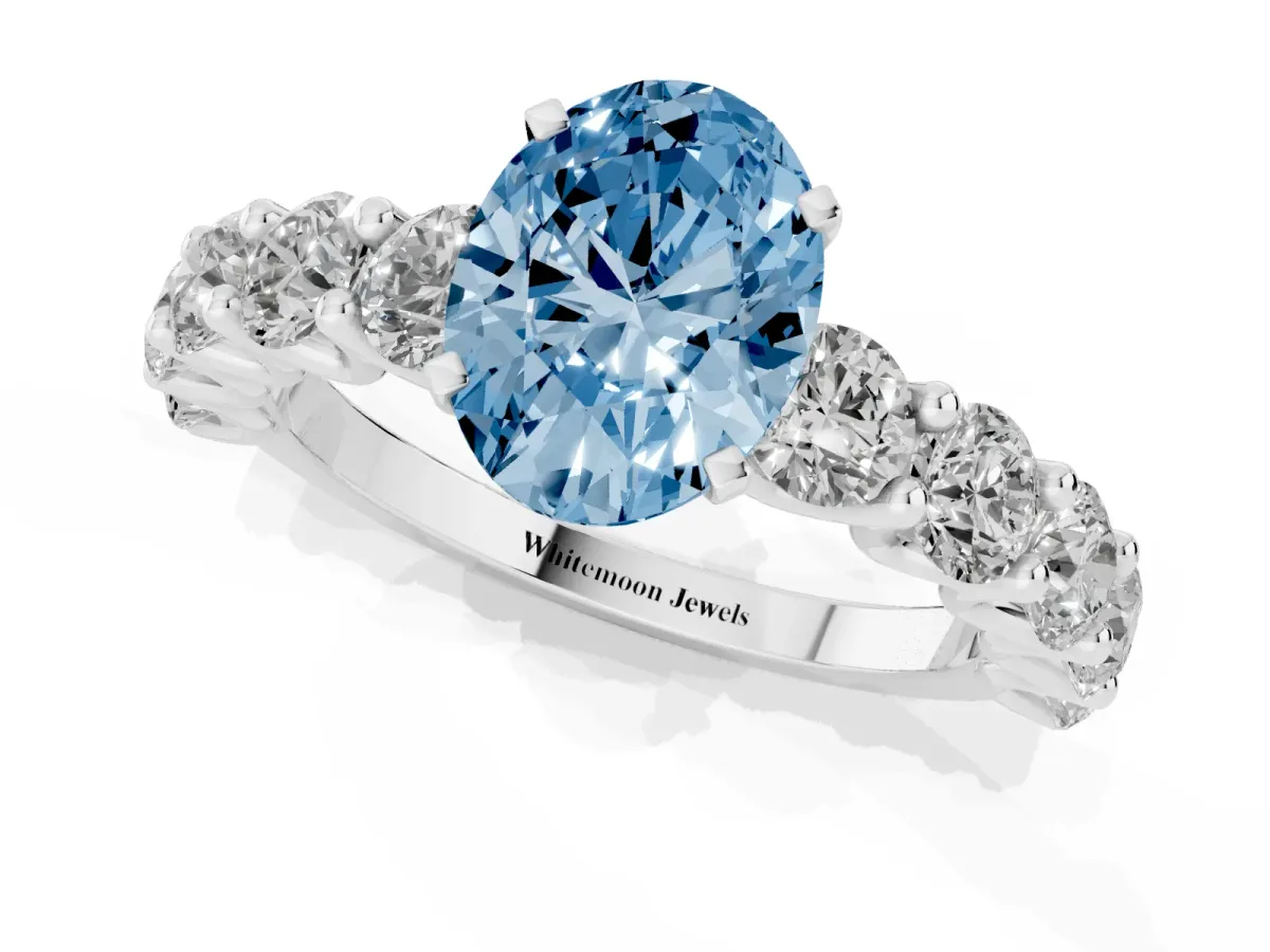 Fancy Blue Oval Cut Diamond Prong Setting with Side Stones on a Pave Band Silver