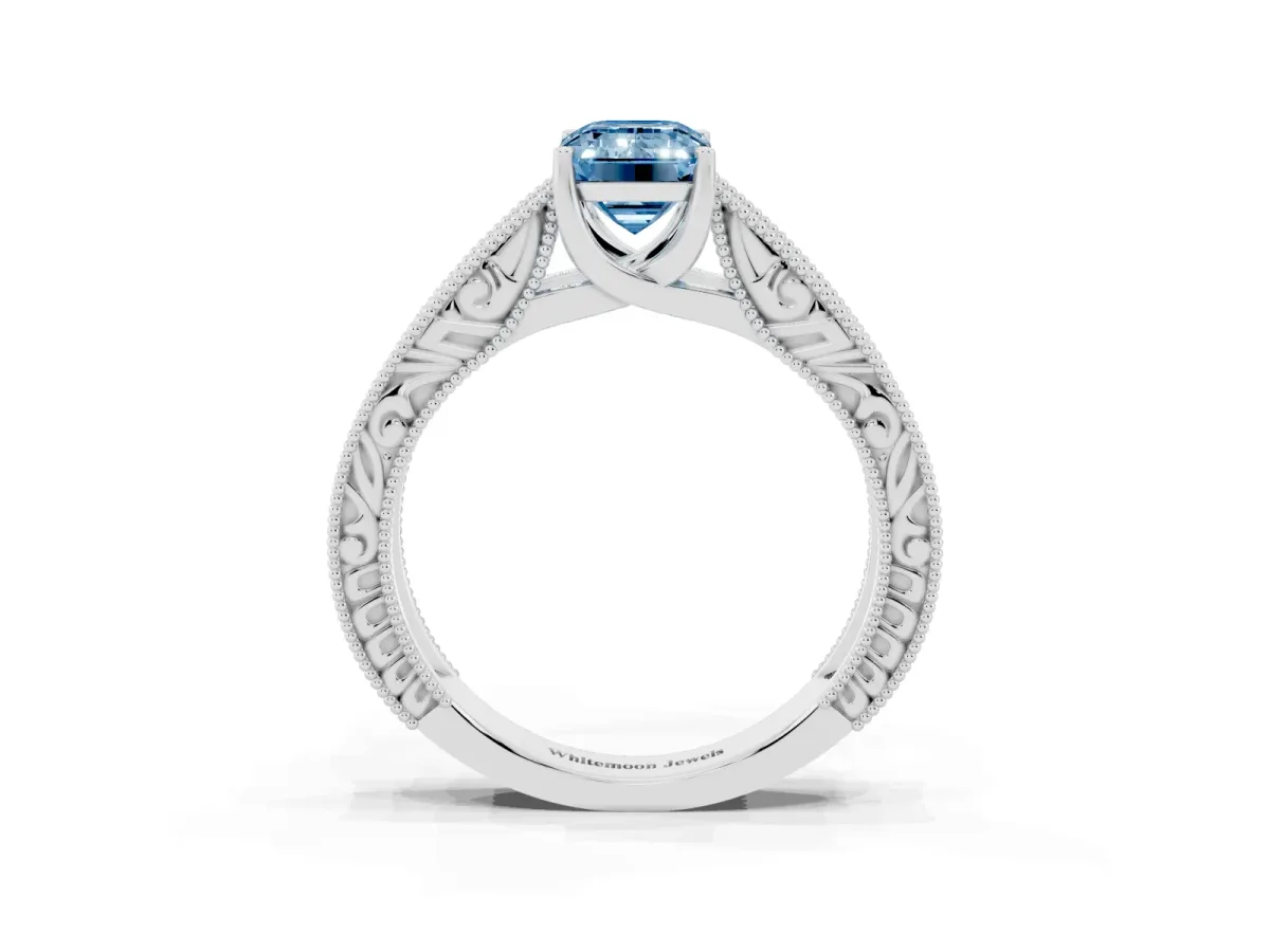Fancy Blue Emerald Cut Diamond Solitaire Ring with Engraved Band and Four-Prong Setting Platinum