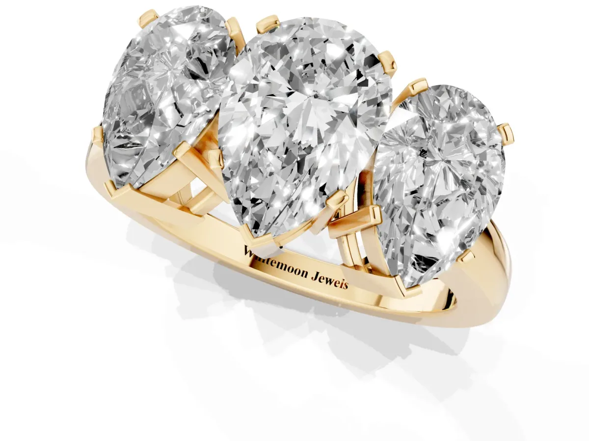 Three-Stone Pear Cut Cut Diamond Ring with Channel Set Band and Four-Prong Setting Yellow gold