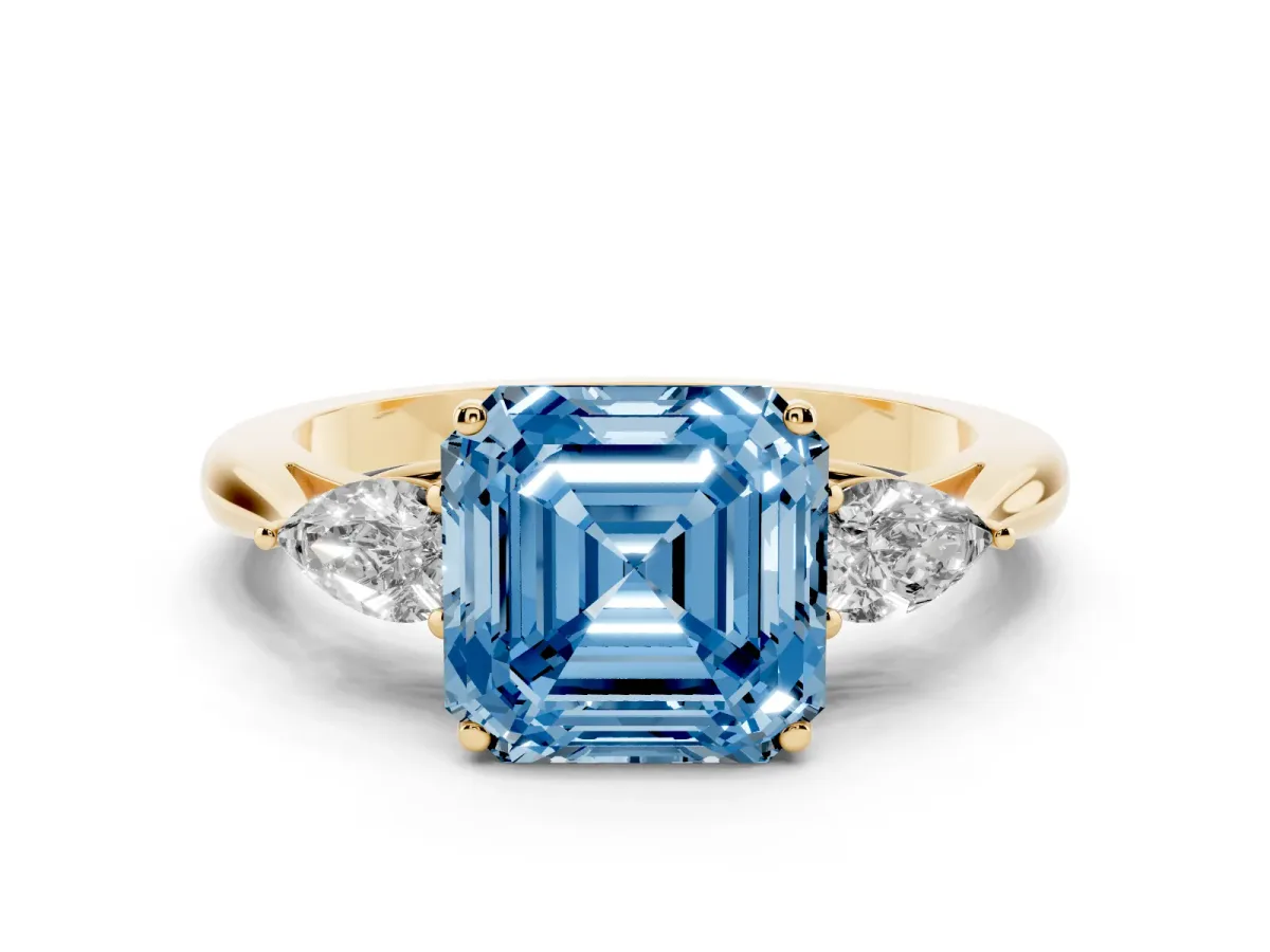 Fancy Blue Three-Stone Asscher Cut Diamond Ring with Pear Side Stones in Four-Prong Setting Yellow gold